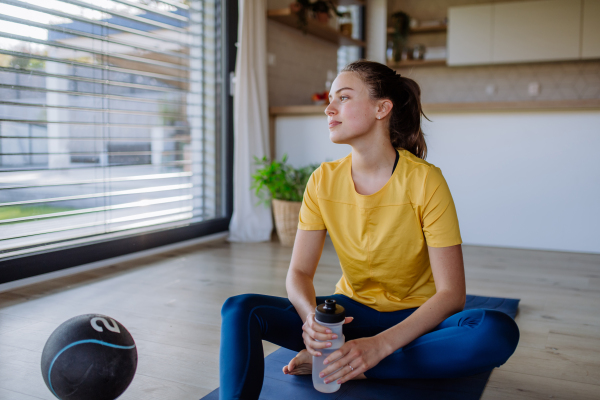 Young woman doing exercises at home.