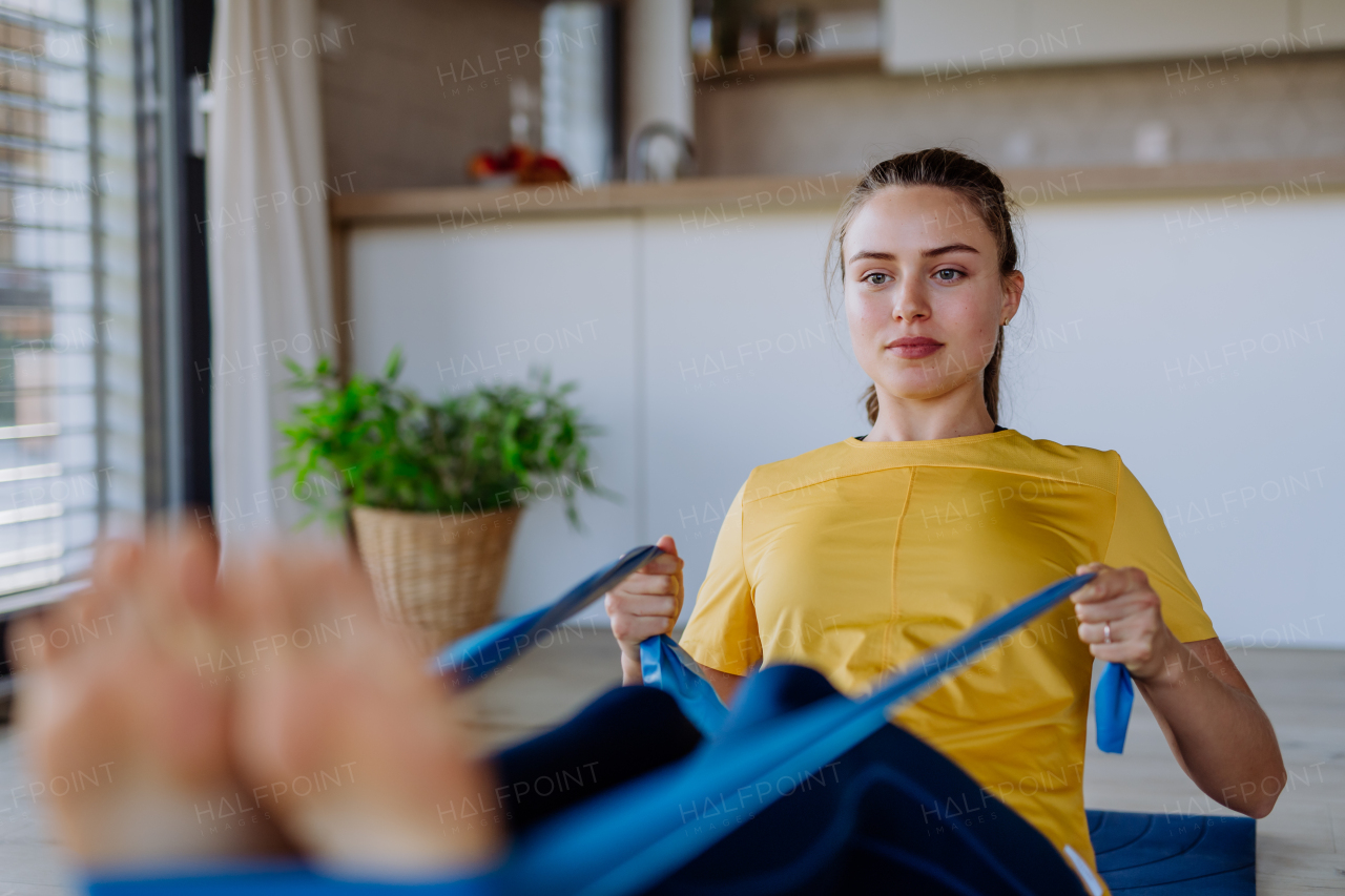 Young woman doing exercises at home.