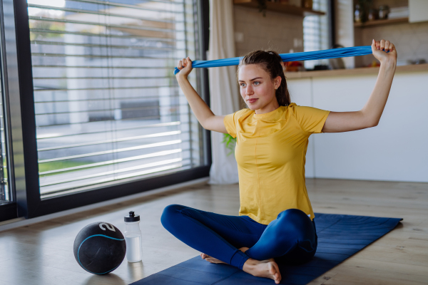 Young woman doing exercises at home.