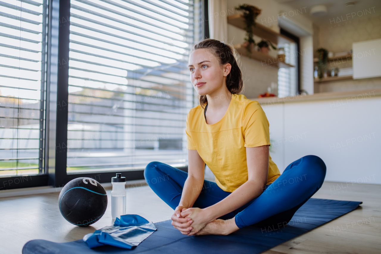 Young woman doing exercises at home.