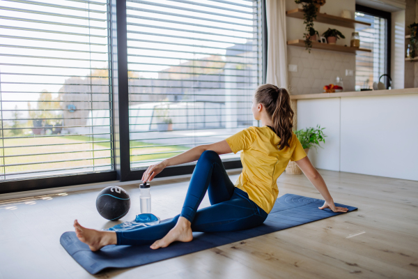 Young woman doing exercises at home.