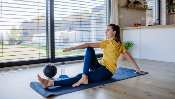 Young woman doing exercises at home.