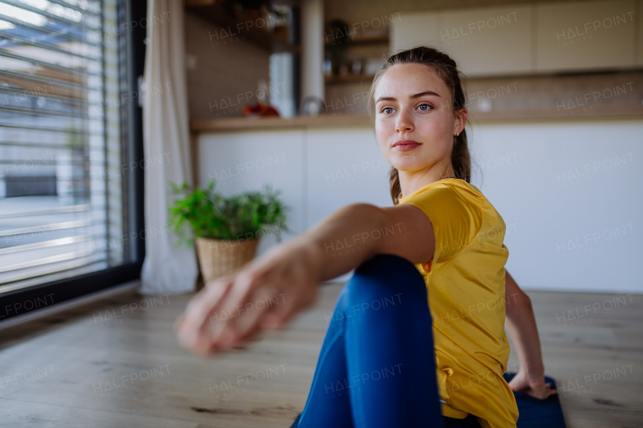 Young woman doing exercises at home.