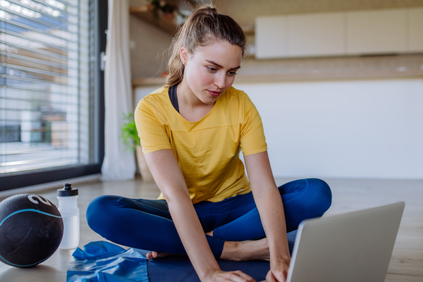 Young woman doing exercises at home.