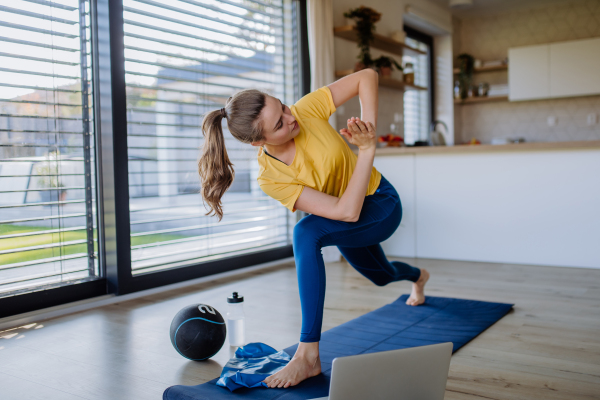 Young woman doing exercises at home.