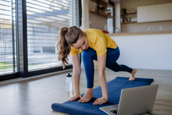 Young woman doing exercises at home.