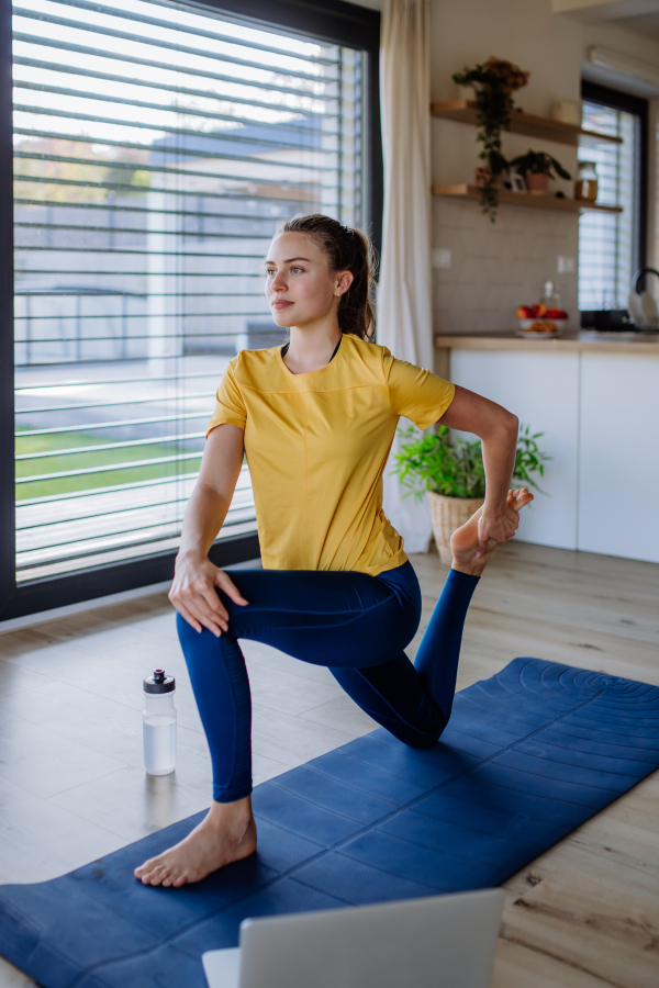 Young woman doing exercises at home.