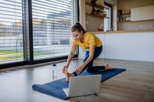 Young woman doing exercises at home.