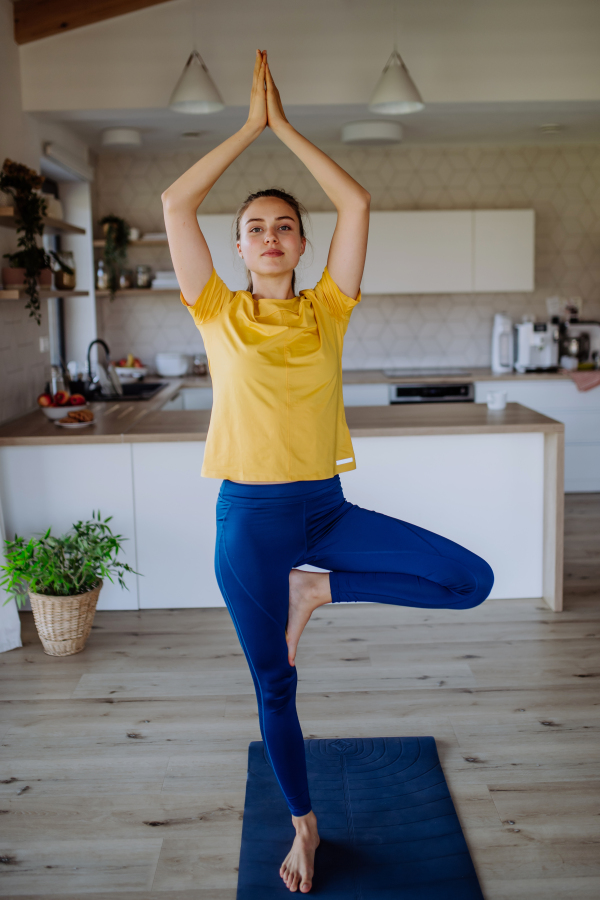 Young woman doing exercises at home.