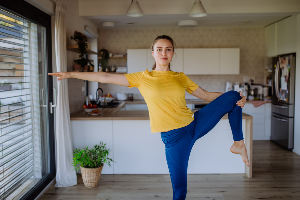 Young woman doing exercises at home.