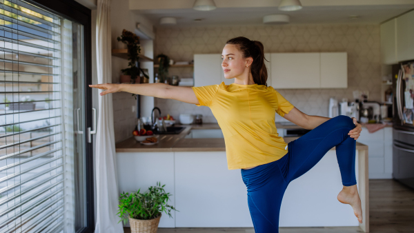 Young woman doing exercises at home.