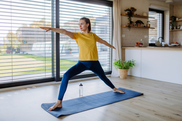 Young woman doing exercises at home.