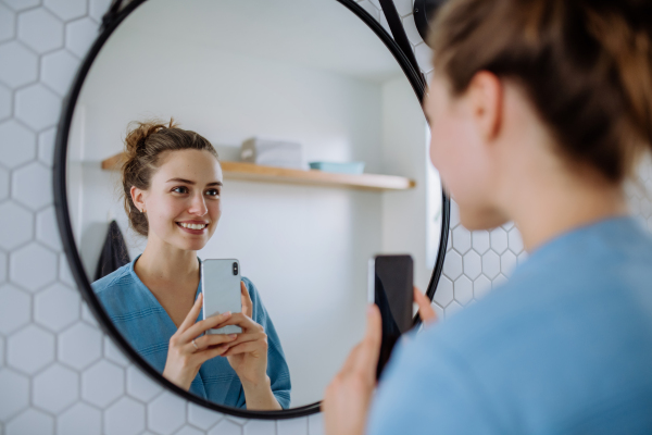 Young woman taking selfie in the bathroom.