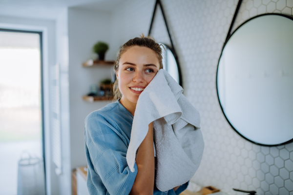 Young woman taking care of her face skin, morning beauty routine concept.