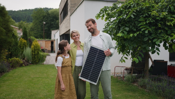 A video of family holding model of solar panel. Sustainable living, green energy in home.