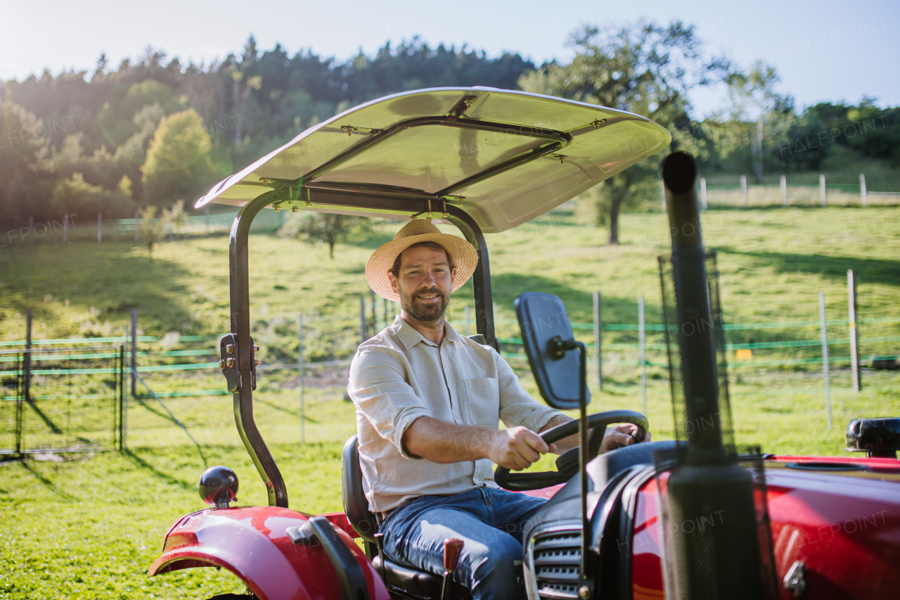 Farmer riding tractor on field. Harvesting crops, collecting vegetables on family farm. Concept of farming and agricultural business.