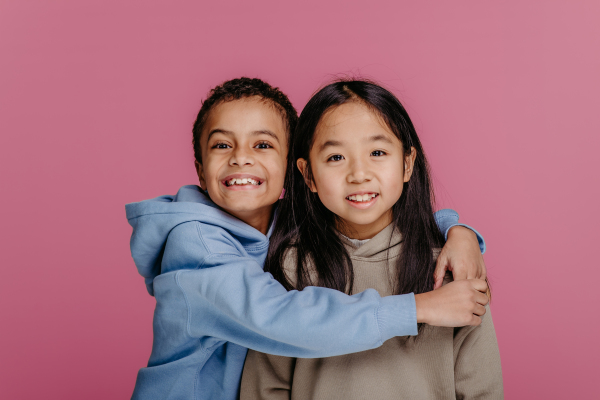 Portrait of two children, studio shoot. Concept of diversity in a friendship.