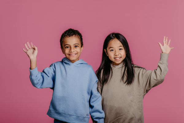 Portrait of two children, studio shoot. Concept of diversity in a friendship.