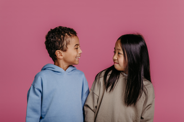 Portrait of two children, studio shoot. Concept of diversity in a friendship.