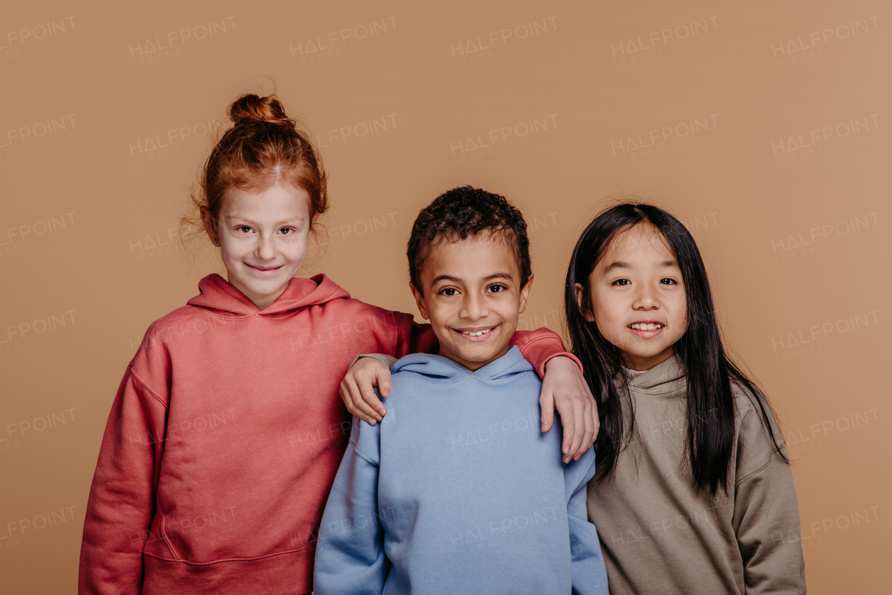 Portrait of three children, studio shoot. Concept of diversity in a friendship.