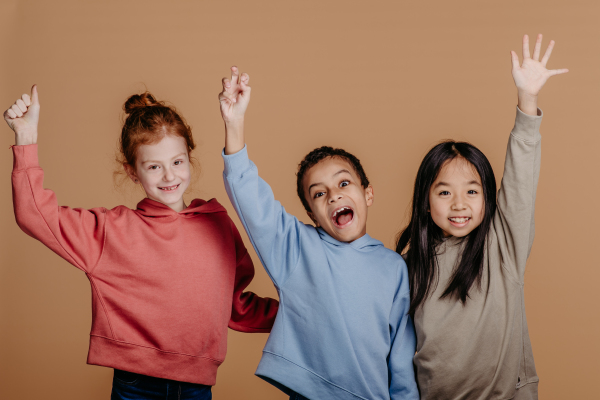 Portrait of three excited children, studio shoot. Concept of diversity in a friendship.