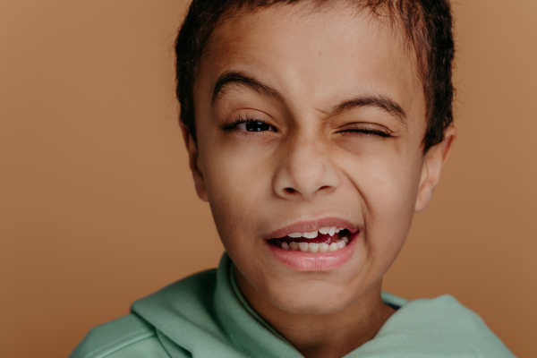 Portrait of a little boy with black hair, studio shoot.