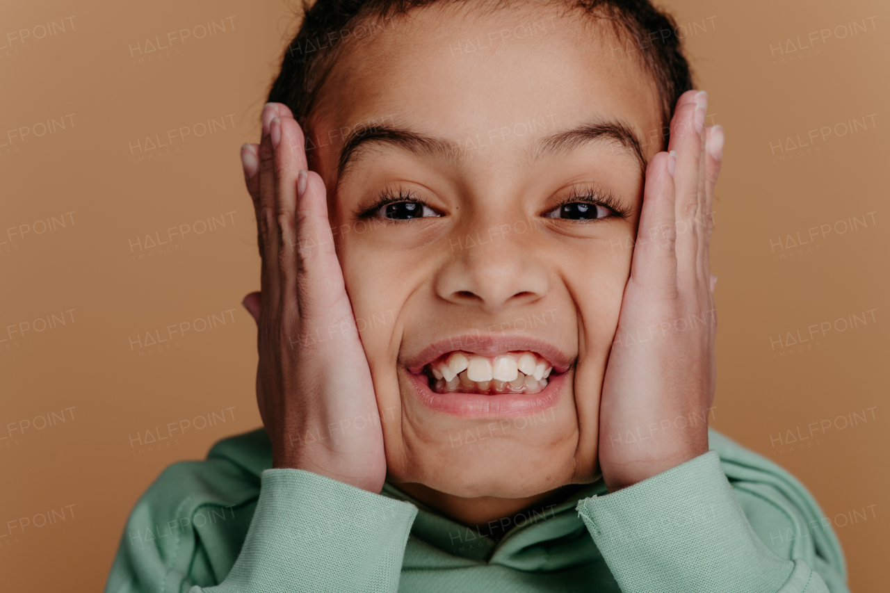 Portrait of a little boy with black hair, studio shoot.