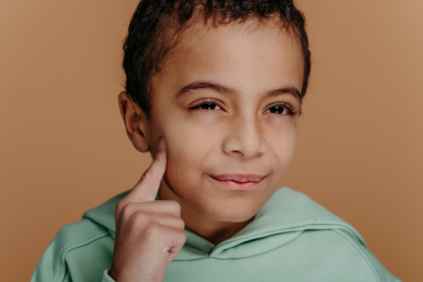 Portrait of a little boy with black hair, studio shoot.