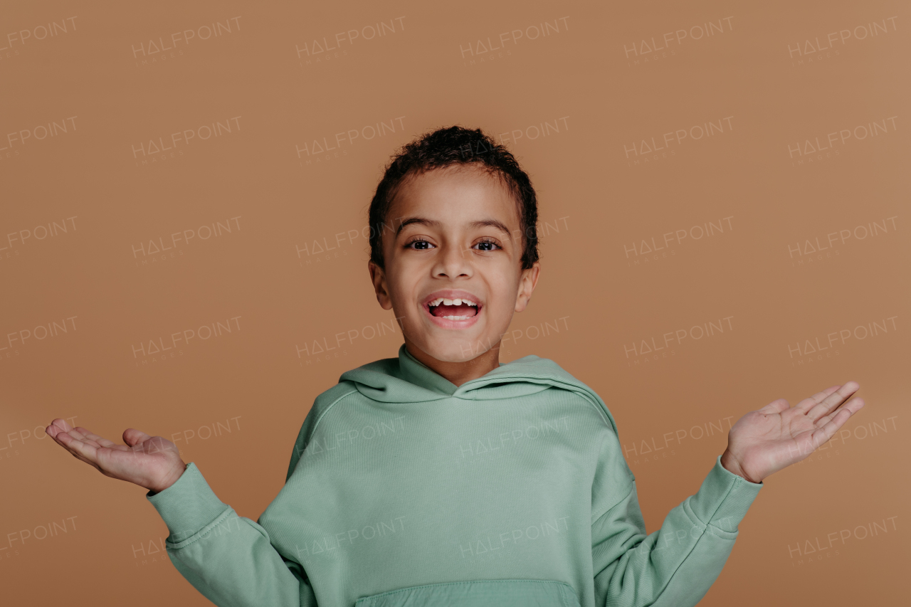 Portrait of a little boy with black hair, studio shoot.