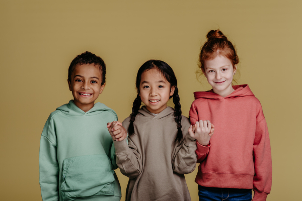 Portrait of three children, studio shoot. Concept of diversity in a friendship.