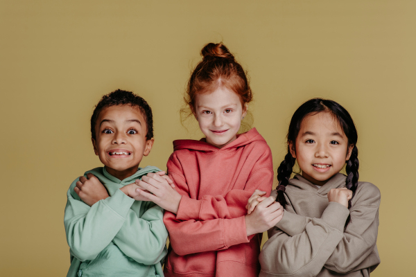 Portrait of three children, studio shoot. Concept of diversity in a friendship.