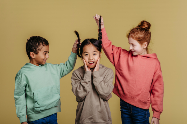 Portrait of three children, studio shoot. Concept of diversity in a friendship.