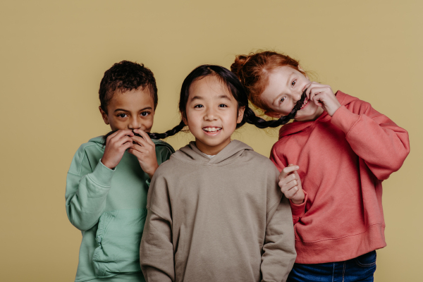 Portrait of three children, studio shoot. Concept of diversity in a friendship.