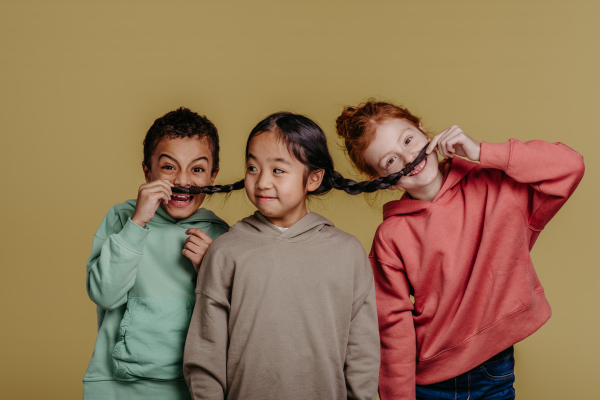 Portrait of three children, studio shoot. Concept of diversity in a friendship.