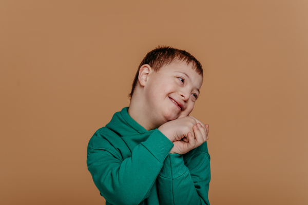 Portrait of a little boy with down syndrome, studio shoot.