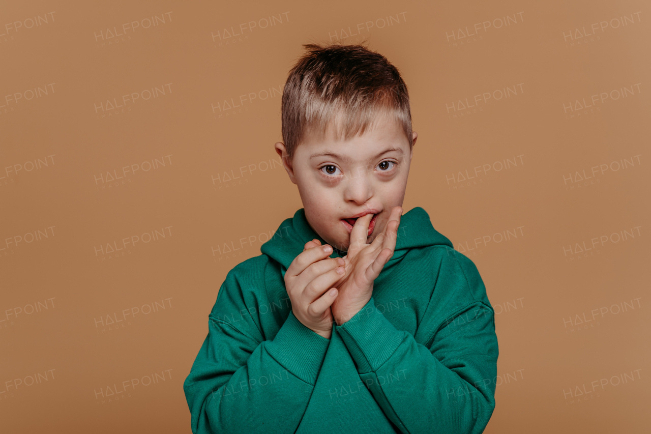 Portrait of a little boy with down syndrome, studio shoot.