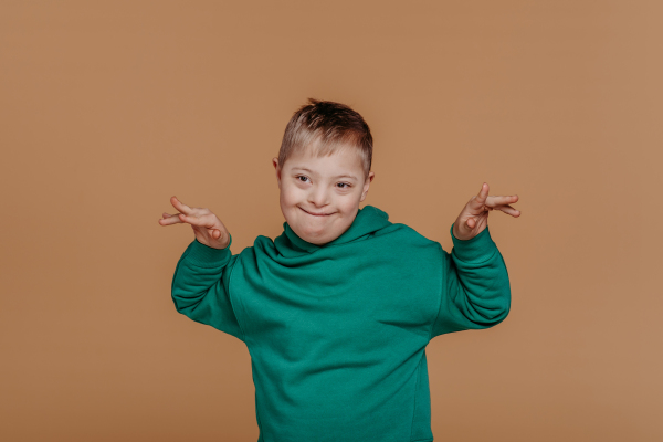 Portrait of a little boy with down syndrome, studio shoot.