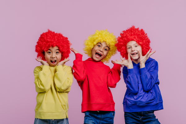 Happy children playing on clown, studio shoot.