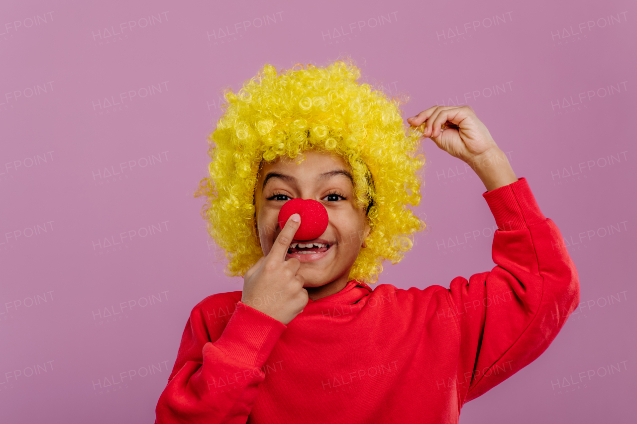 Portrait of little boy in clown costume, studio shoot.