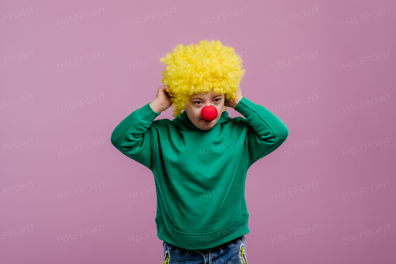 Portrait of a little boy with down syndrome, in carnival costume.