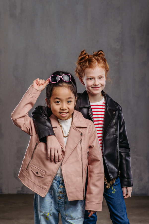 Portrait of two girls in a leather jacket.