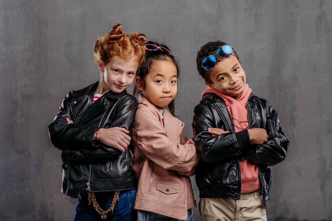 Portrait of three children in a leather jacket.