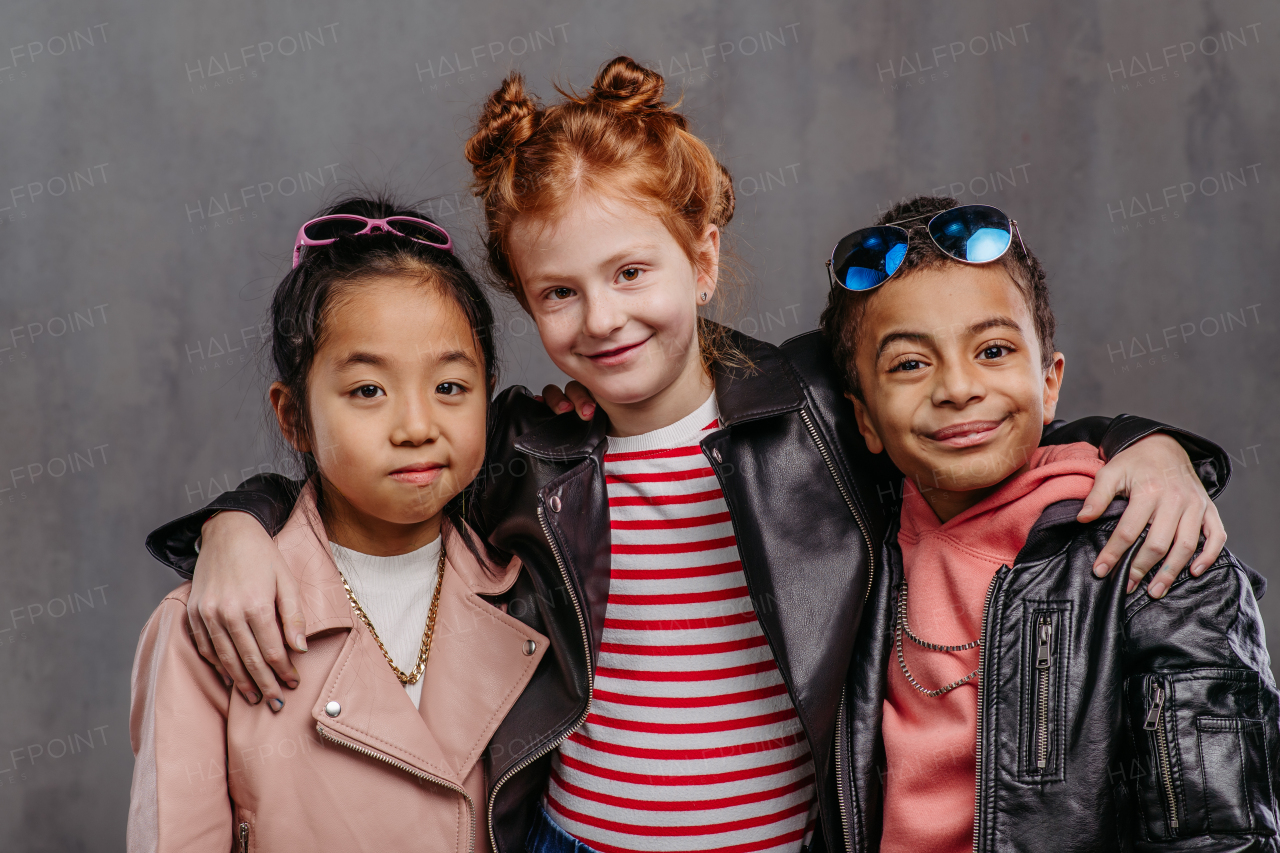 Portrait of three children in a leather jacket.