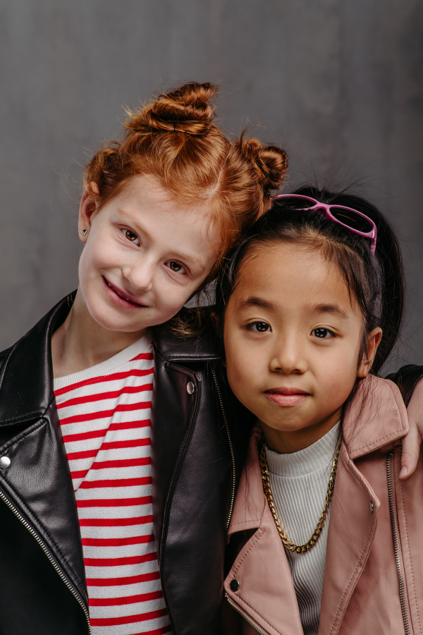 Portrait of two girls in a leather jacket.