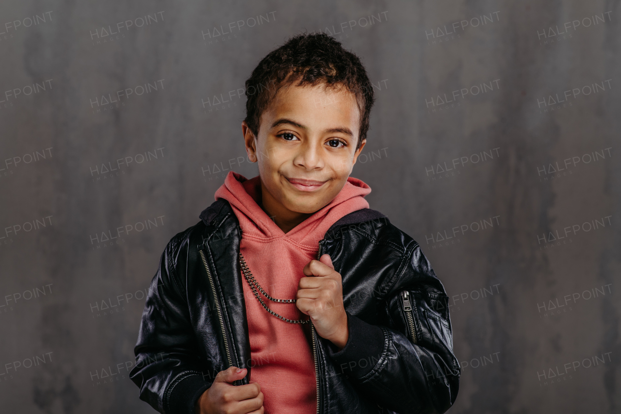 Portrait of little multiracial boy in a leather jacket.