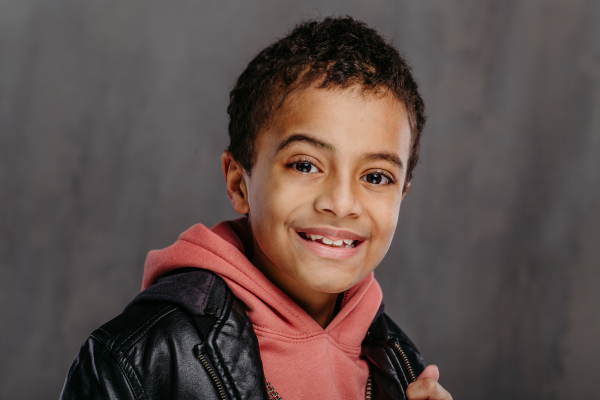 Portrait of little multiracial boy in a leather jacket.