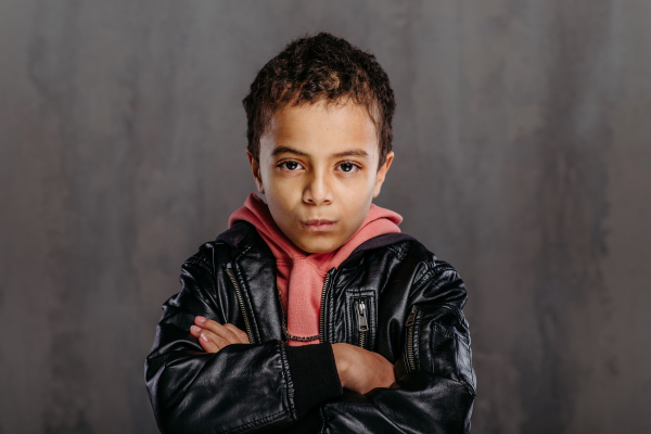 Portrait of little multiracial boy in a leather jacket.