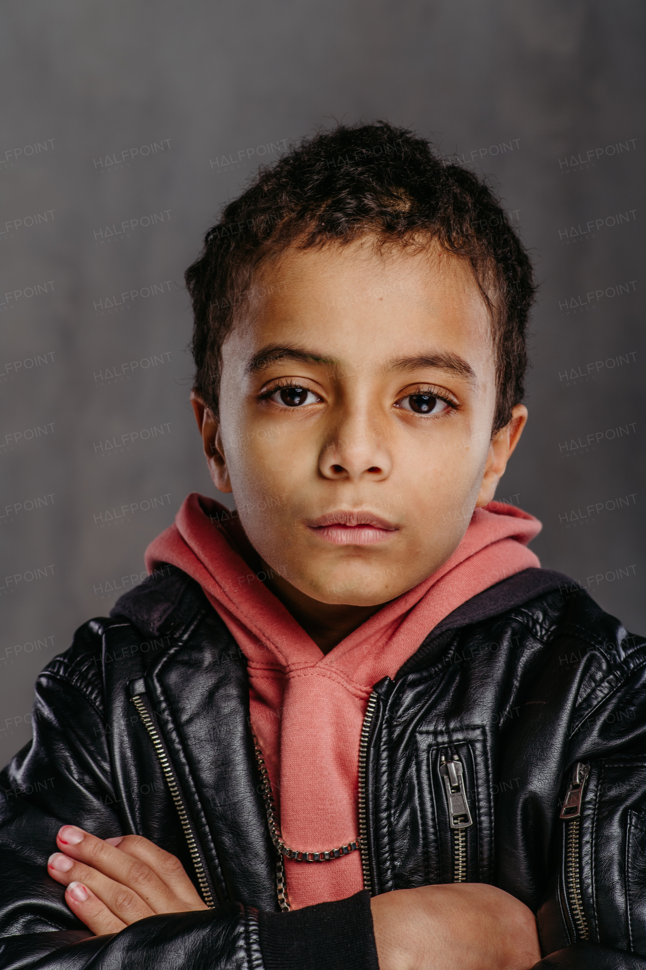 Portrait of little multiracial boy in a leather jacket.