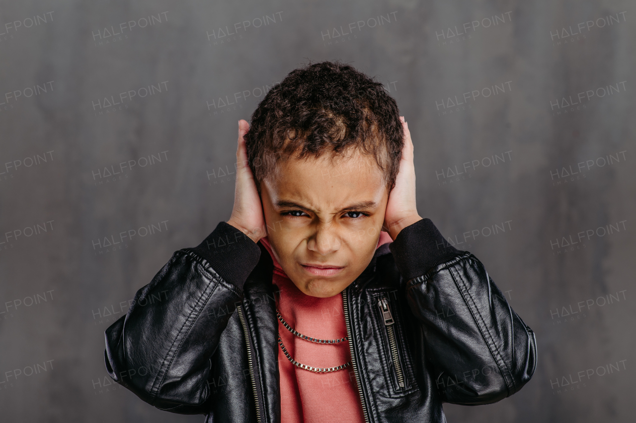 Portrait of little multiracial boy in a leather jacket.