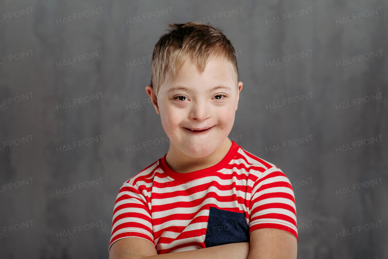 Portrait of a little boy with down syndrome, studio shoot.